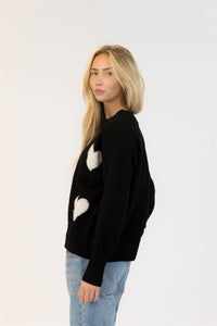 Side angle of Lyla & Luxe Ajax Sherpa Sweater featuring oversized hearts and relaxed fit