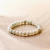 Seafoam green Amazonite bracelet on reflective marble surface