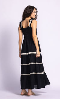Back view of the Amber Dress by Pink Martini, showcasing delicate eyelet details and ruffle accents.