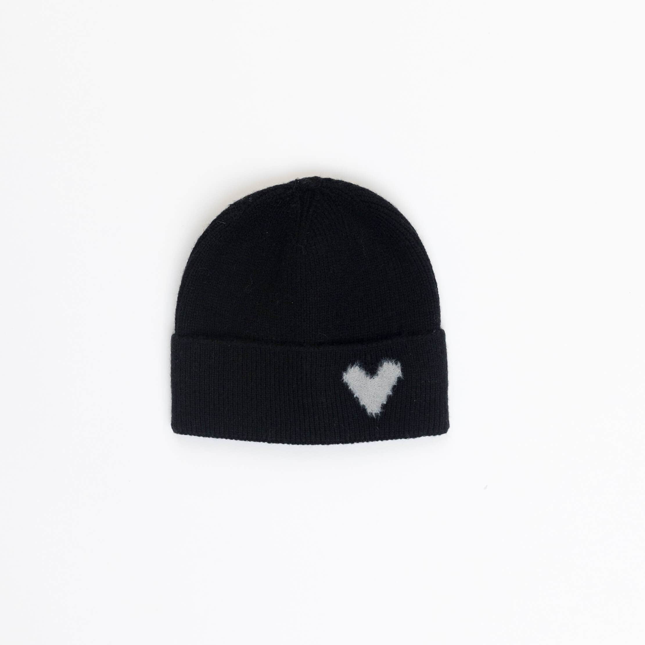 Black beanie with a white heart pattern on a light gray background