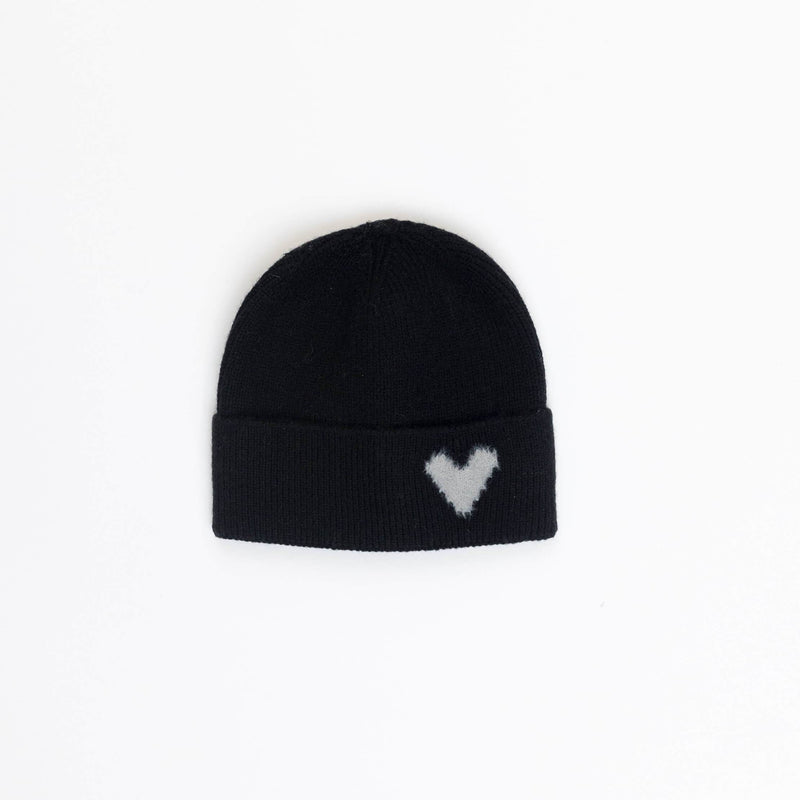 Black beanie with a white heart pattern on a light gray background