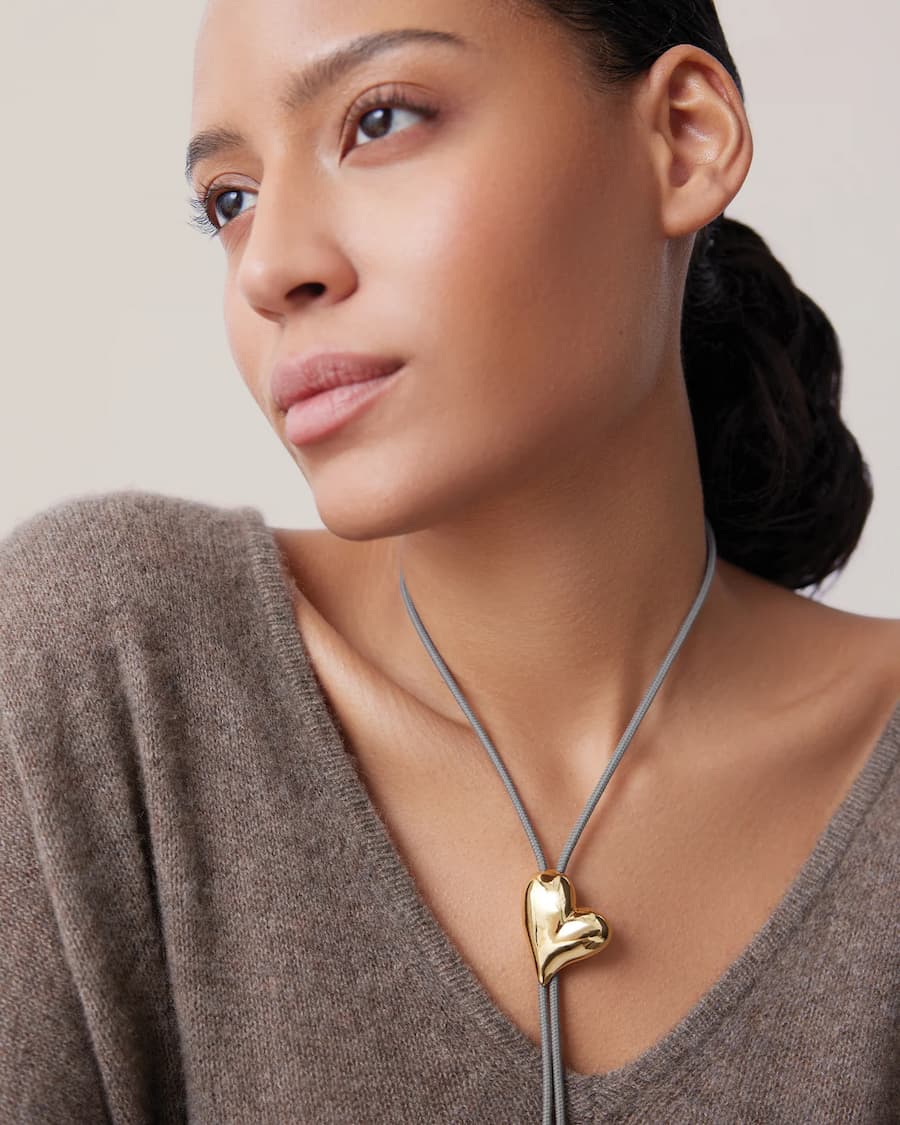 Gold heart bolo tie necklace worn on model, Jenny Bird — Lemonberry Aurora