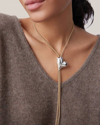 Silver heart bolo tie necklace worn on model, Jenny Bird — Lemonberry Aurora