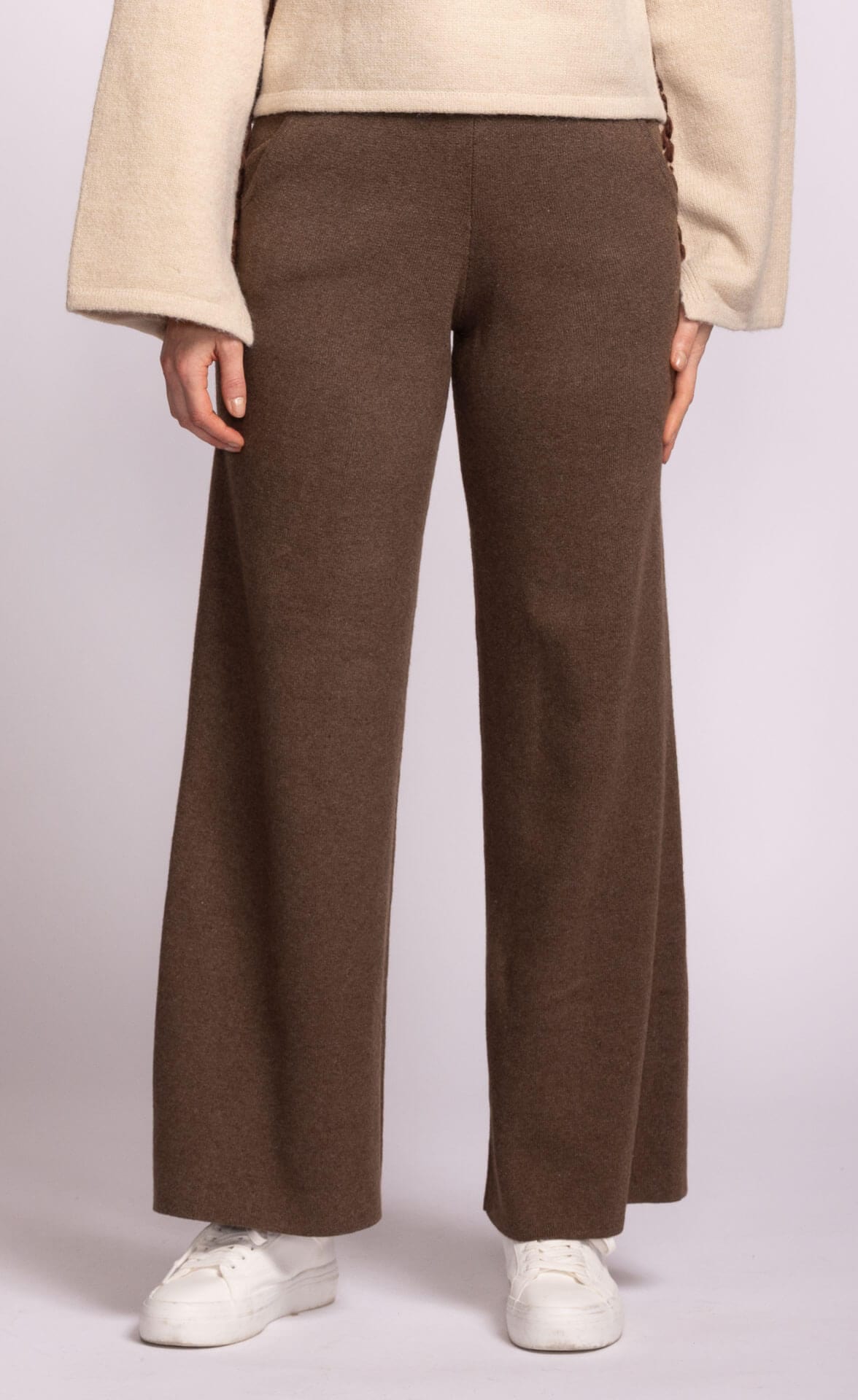 Wide-leg brown knit pants by Pink Martini, photographed front-on with cream sweater and white sneakers, available at Lemonberry just north of Richmond Hill.
