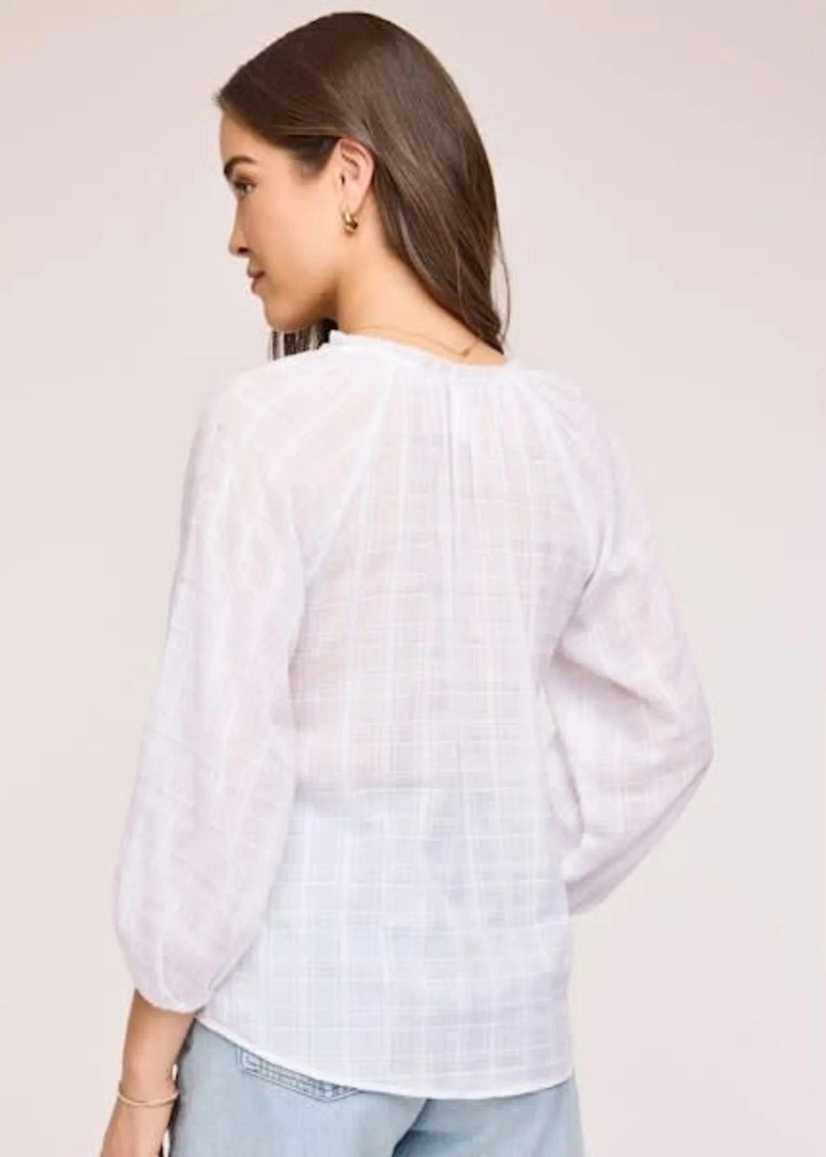 Back side of the stylish and comfortable Atlas blouse in white at Lemonberry. 