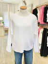Front view of the Beach Comber relaxed boatneck sweater in white with denim – A soft-fit boatneck sweater in white linen-cotton blend, paired with denim. Available at Lemonberry, Aurora, ON.