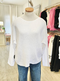Front view of the Beach Comber relaxed boatneck sweater in white with denim – A soft-fit boatneck sweater in white linen-cotton blend, paired with denim. Available at Lemonberry, Aurora, ON.