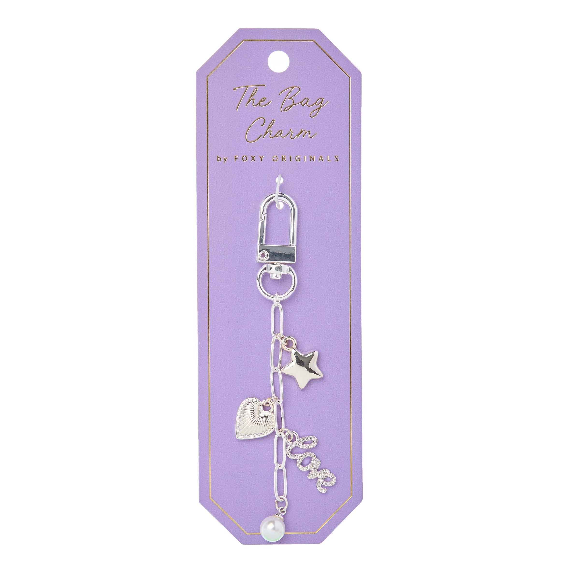 Silver Bella Bag Charm by Foxy Originals on lavender backing card with gold text