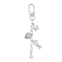 Bella Bag Charm by Foxy Originals in silver with star, heart, pavé “love” charm, and pearl drop