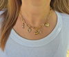 Gold Bella Charm Necklace with five charms styled on model in ribbed white top – Foxy Originals at Lemonberry