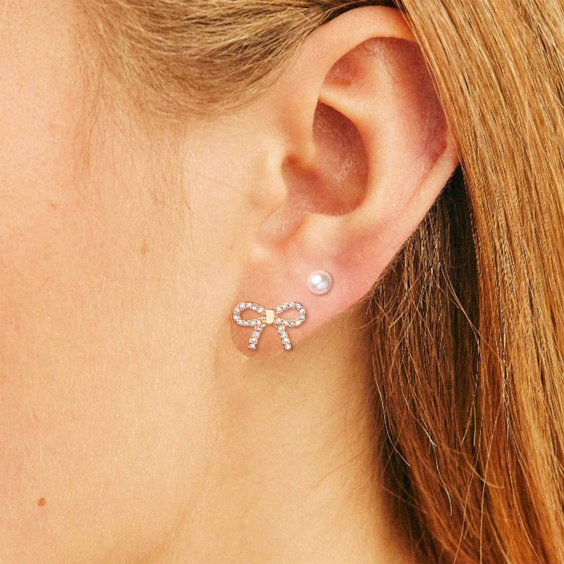 Bella Mix & Match Earrings by Foxy Originals – pavé bow stud in gold worn on model with pearl stud accent