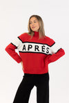 Woman wearing a red sweater with 'APRES' text on a white background