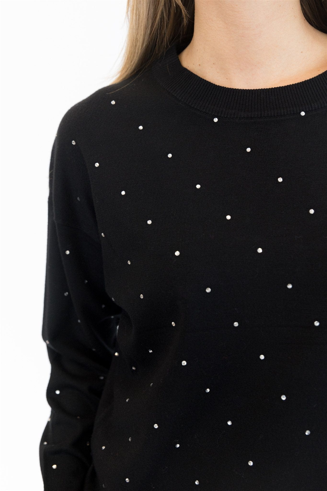 Black sweater with white polka dots on a white background