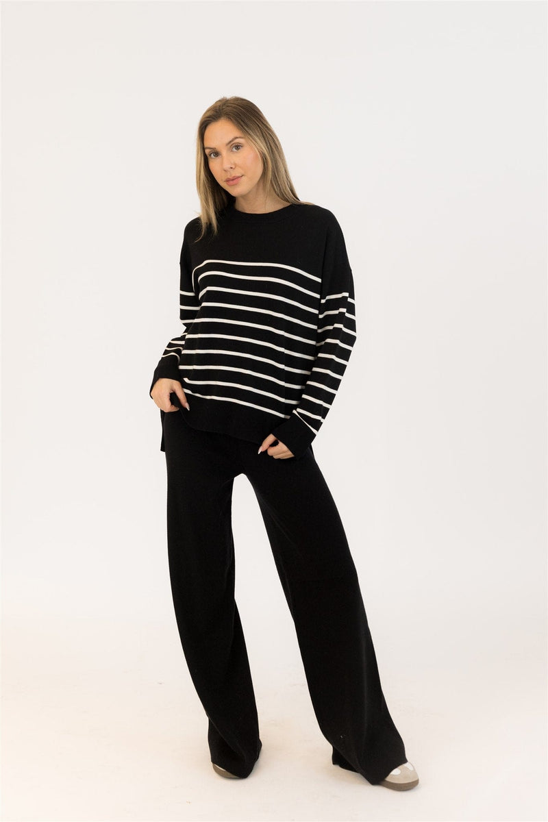 Full-length photo of Billie sweater styled with black wide-leg pants, studio lighting