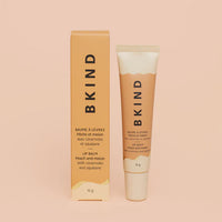BKIND peach and melon lip balm tube and box on peach background — Lemonberry Aurora