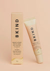 BKIND pear and vanilla lip balm tube leaning on fresh pear — Lemonberry Aurora