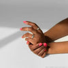 Model showing off her fingers with Bkind's flamingo on her nails.