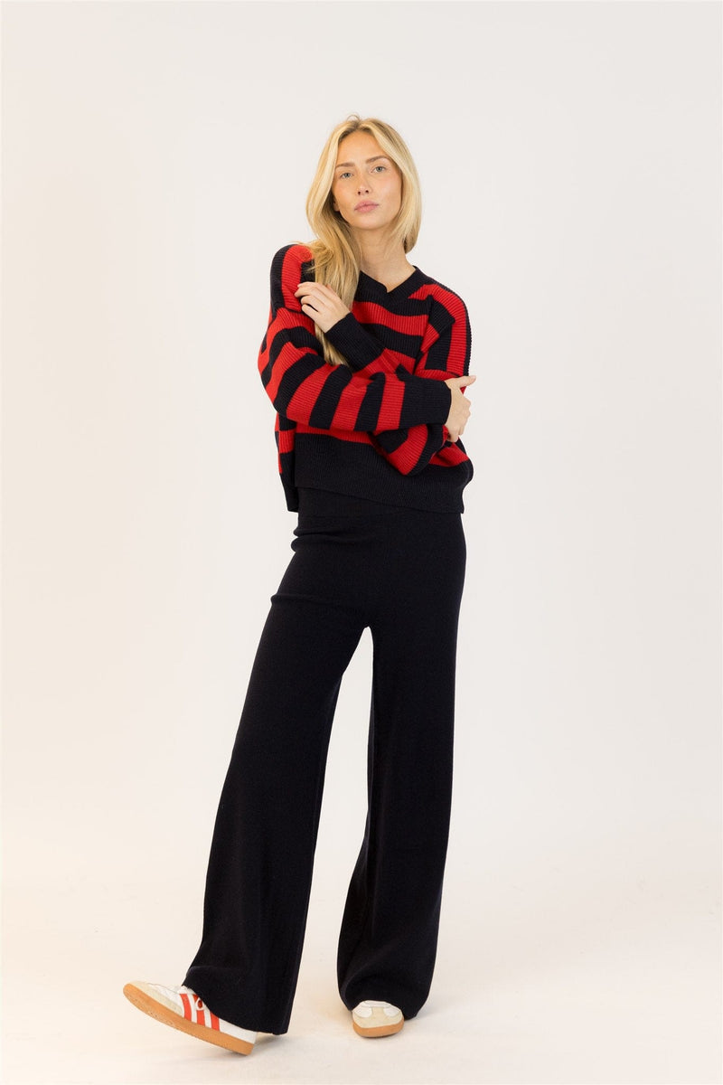 Woman wearing red and navy striped Lyla & Luxe Bobby Crewneck and black wide-leg pants, standing in studio (main product image)