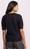 Back view of Pink Martini Bonjour Sweater in black with red “Bonjour” lettering – available at Lemonberry, Aurora boutique.