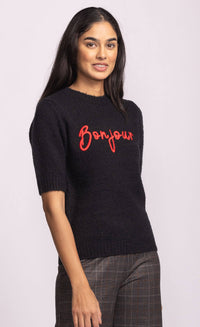 Side view of black Pink Martini Bonjour Sweater showing relaxed fit and red embroidered lettering – Lemonberry women’s knitwear.