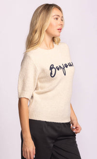 Side view of beige Pink Martini Bonjour Sweater with navy “Bonjour” script – women’s knitwear available online at Lemonberry.