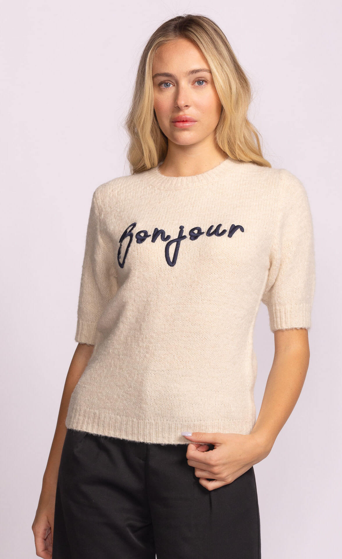 Close-up of beige Pink Martini Bonjour Sweater showing navy embroidered script detail – soft knit available at Lemonberry.