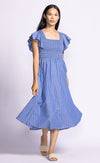 Front view of model in the Camille Dress, with a slight turn showing the flattering A-line fit and seersucker top.