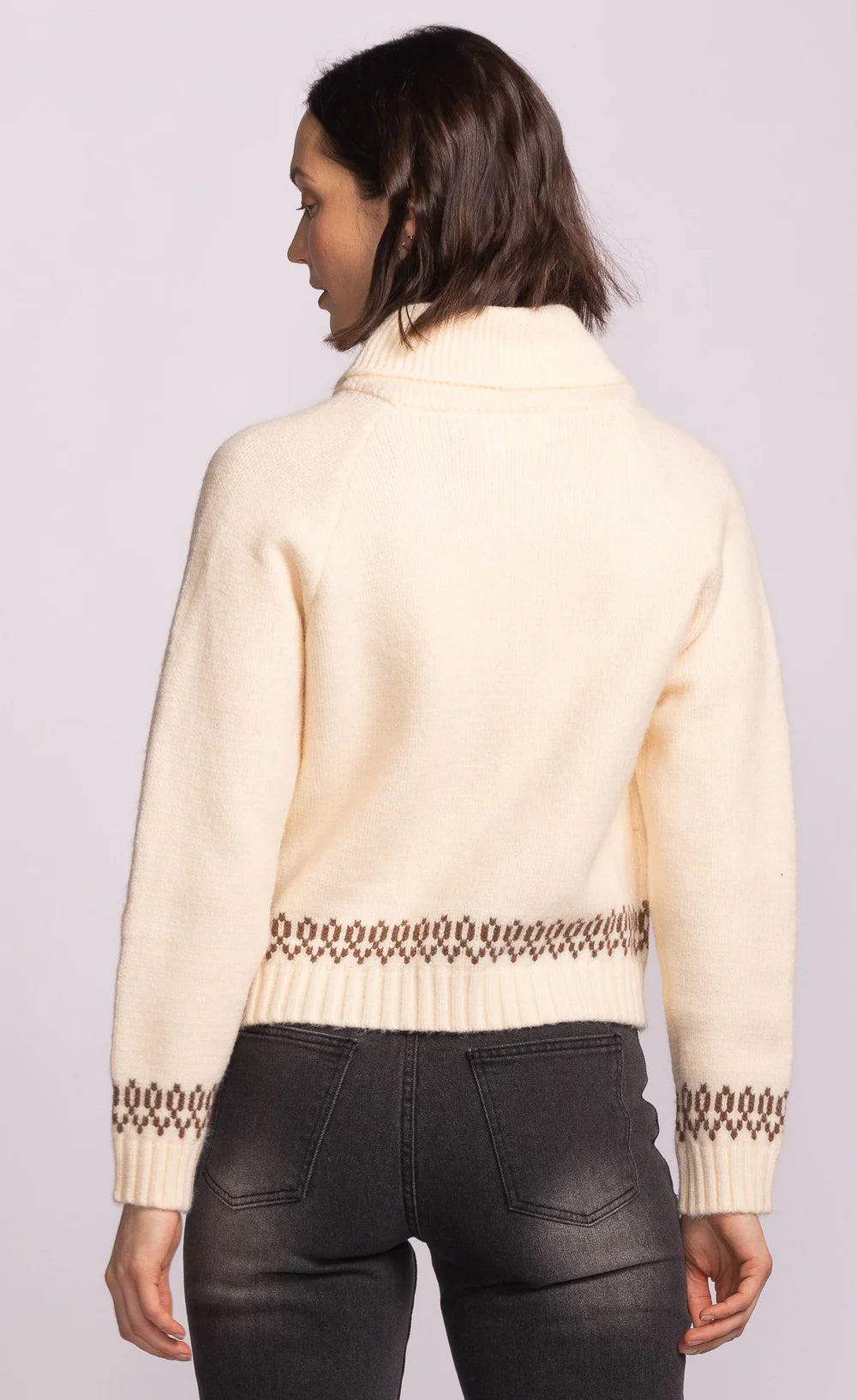 back view of Capella Sweater in cream knit with patterned hem and cuffs