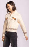 Side view of Capella Sweater showing horse embroidery and heritage knit cuffs