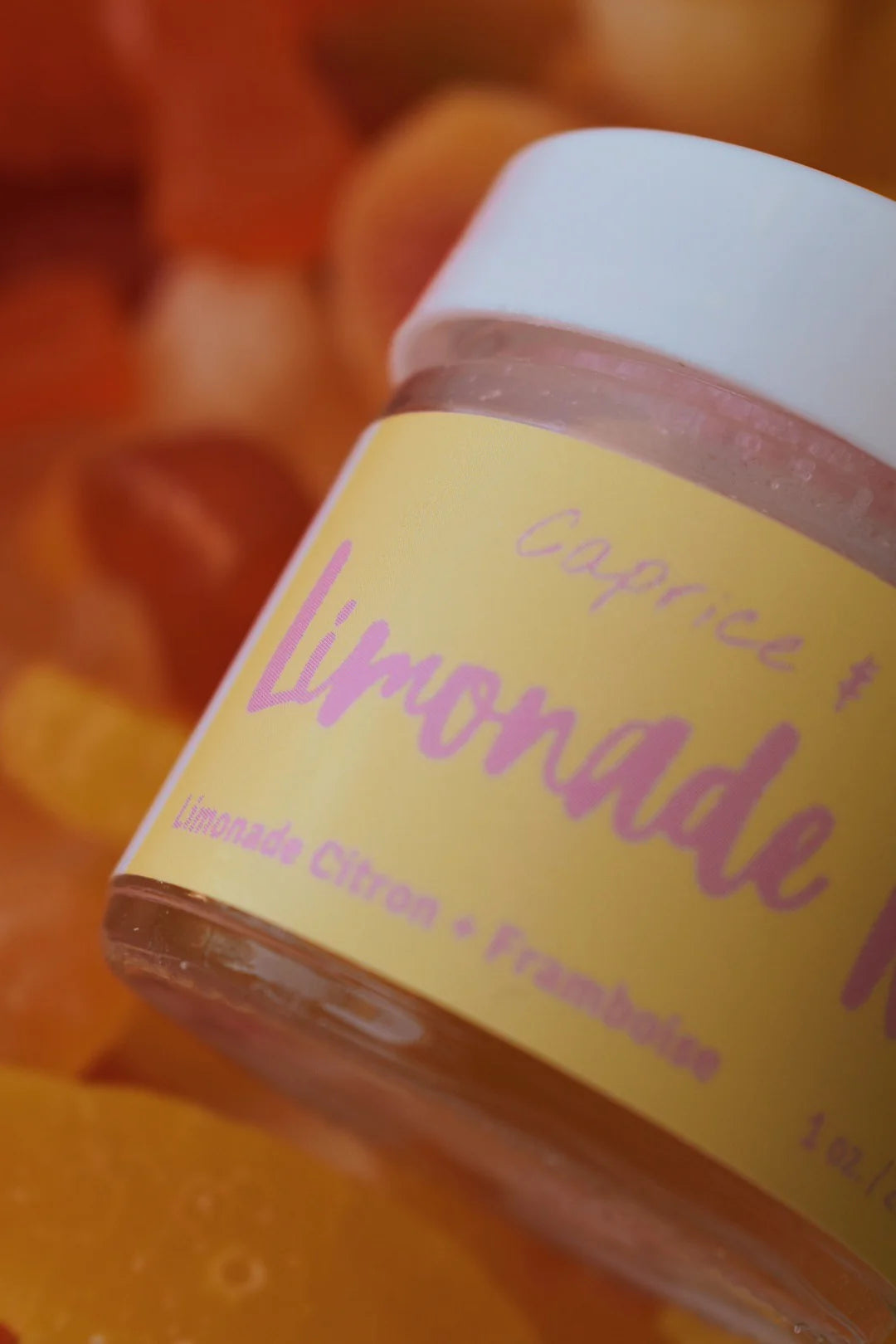 Jar of Caprice & Co Limonade Rose lip scrub with a yellow label on a blurred background