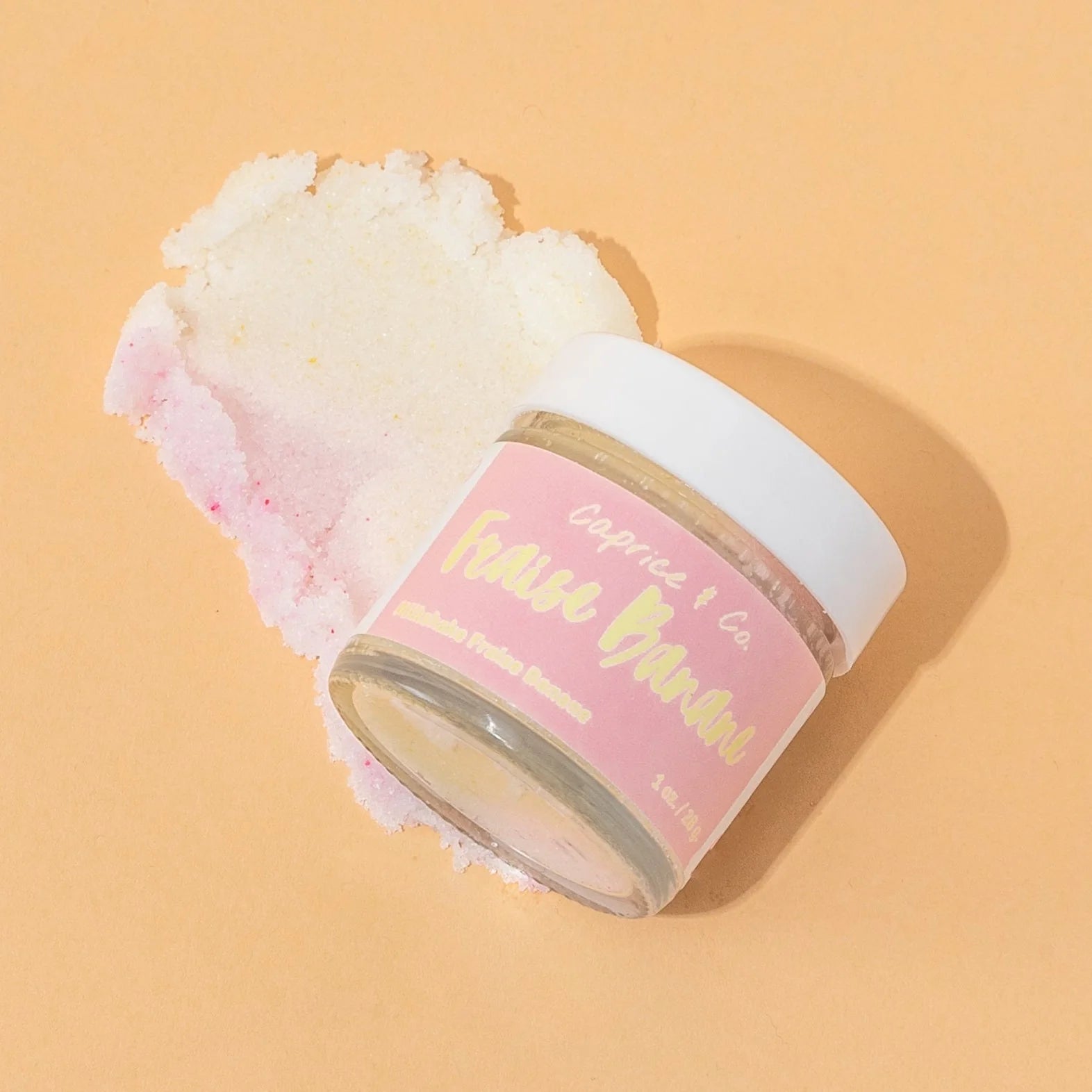 Closed jar of Caprice & Co Strawberry Banana lip scrub showing sugar exfoliating texture