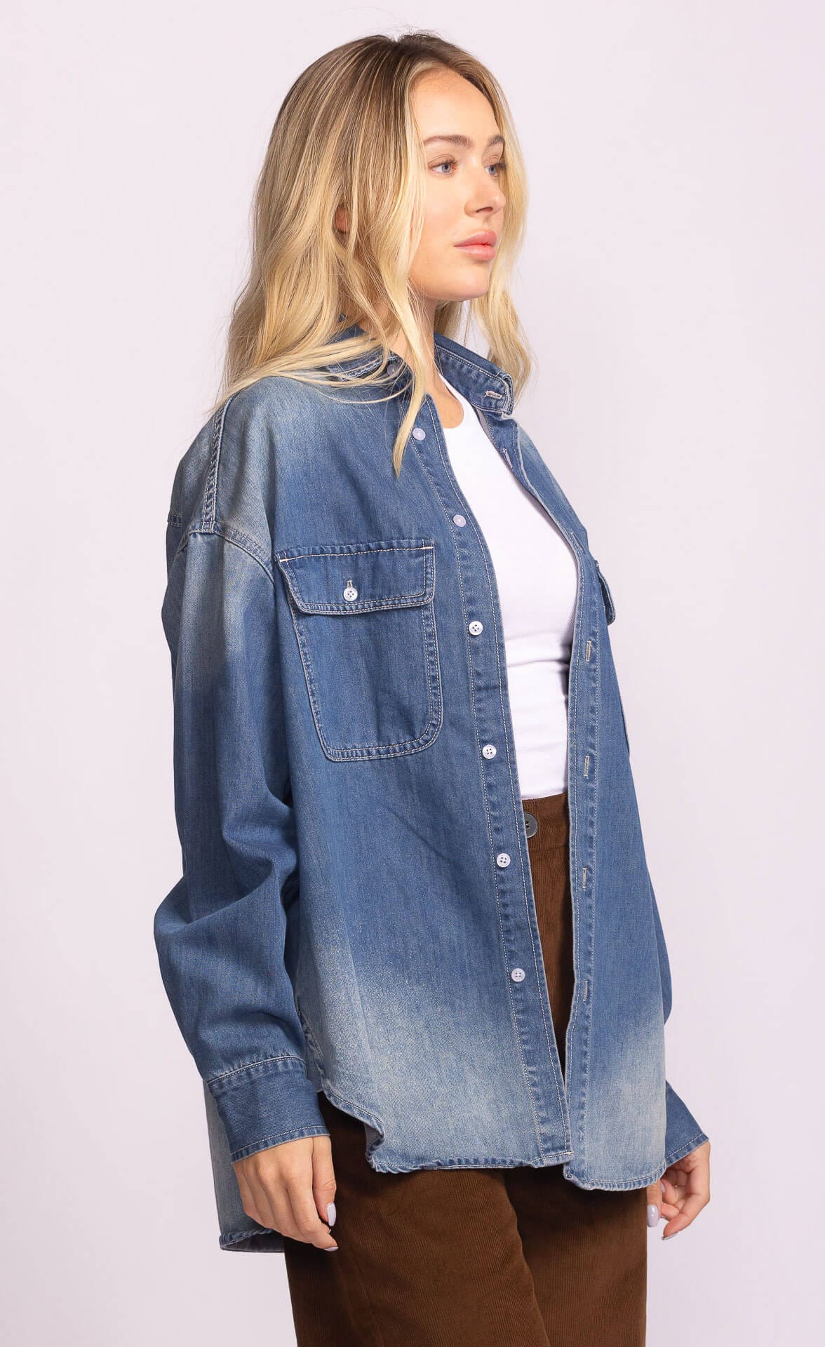 Side profile of Pink Martini Carter Jacket in washed denim with curved hem
