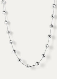 Silver Celeste Necklace by Jenny Bird, laid flat on white background, with elongated metal beads and high-polish finish.