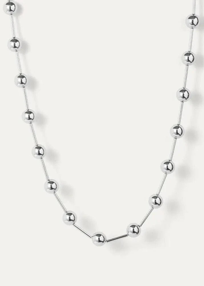 Silver Celeste Necklace by Jenny Bird, laid flat on white background, with elongated metal beads and high-polish finish.