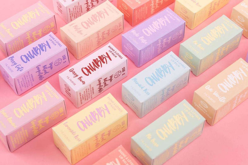 Flat lay of CHUBBY eco lip balm boxes on pink background