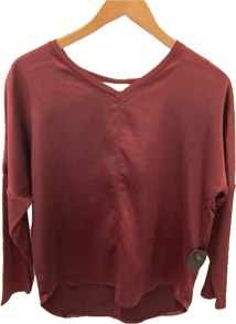 Melissa Nepton's Cindy long sleeve top on a wooden hanger against a plain background