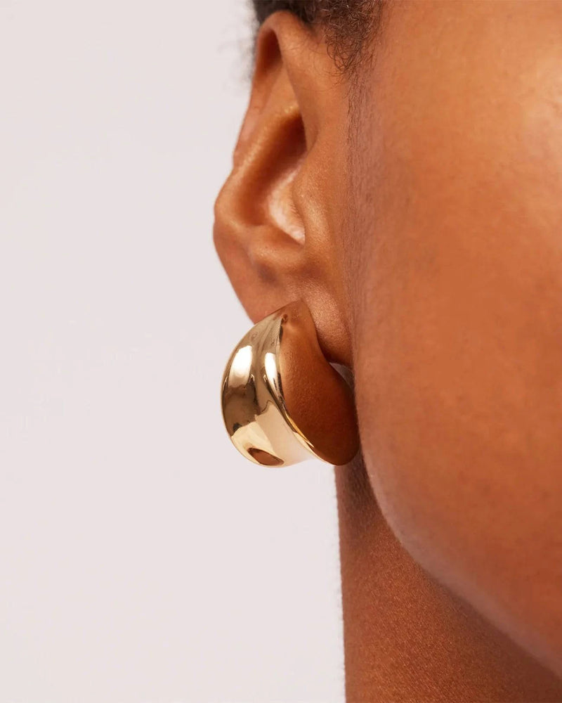 Close up of the Nouveaux Puff Earrings by Jenny Bird on a models ear. 