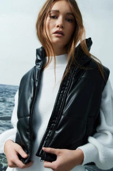 Clyde Vest by Melissa Nepton styled over white knit, ocean backdrop, available at Lemonberry