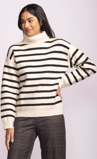 Model wearing Pink Martini Corsica Sweater in cream with black stripes, front view.