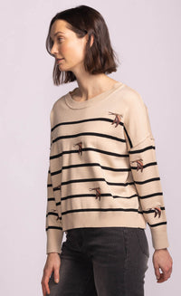 Side view of the Cruz Sweater in beige with black stripes and swallow embroidery, relaxed fit from Lemonberry.