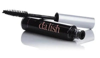 Open bottle of Dalish mascara resting on its container. 