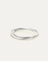 Flat lay of silver Dane Bangle — rhodium finish with hinge detail