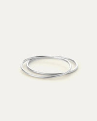 Flat lay of silver Dane Bangle — rhodium finish with hinge detail