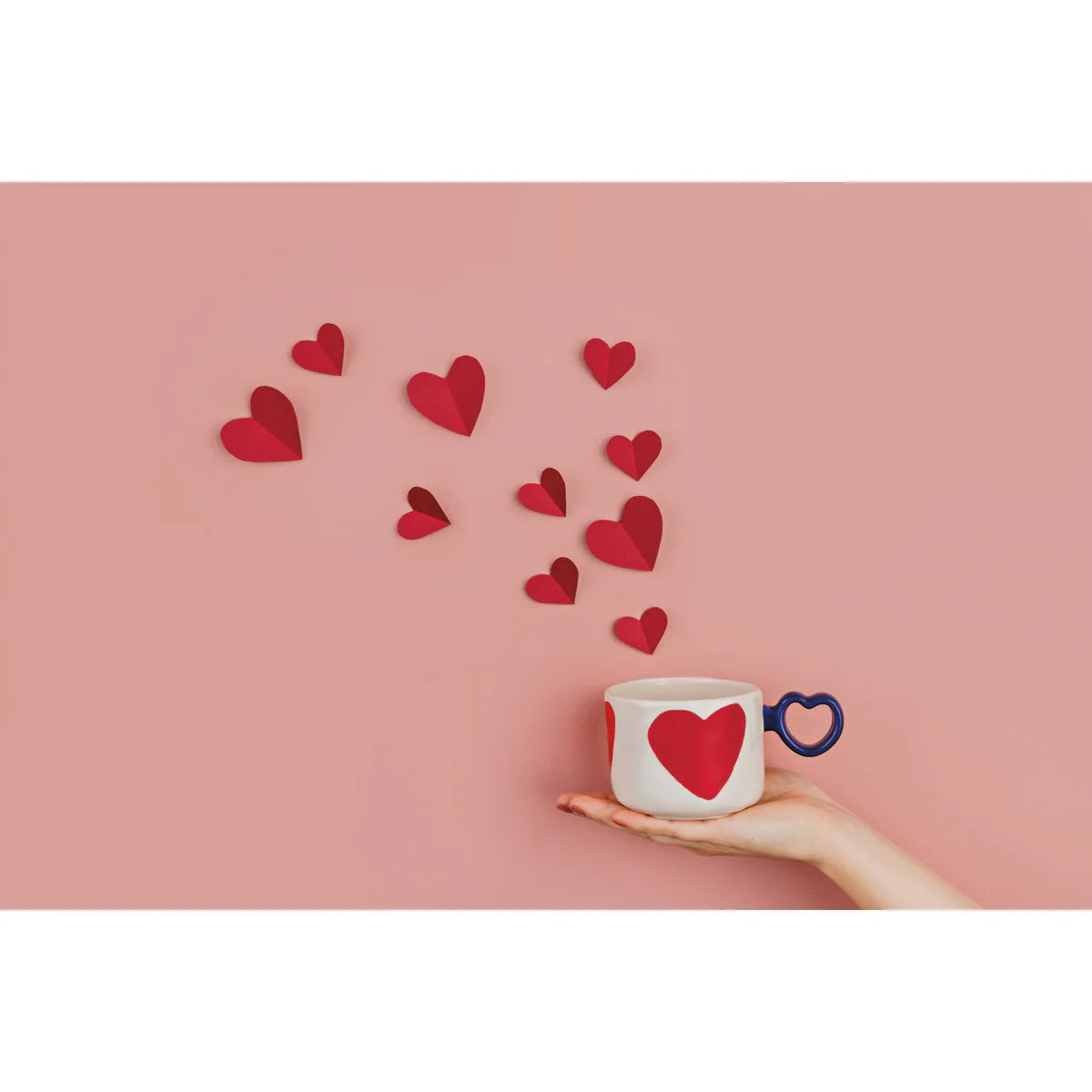 Danica I Heart You Mug stoneware 11oz with red heart motif and heart shaped handle styled against pink background at Lemonberry Aurora