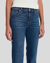 Blue jeans worn by a person on a white background