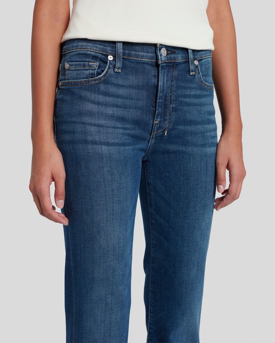 Blue jeans worn by a person on a white background