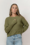 Front view of Echo Verde Sailing Sweater in Thyme green, relaxed high-low hem and long cuffs.