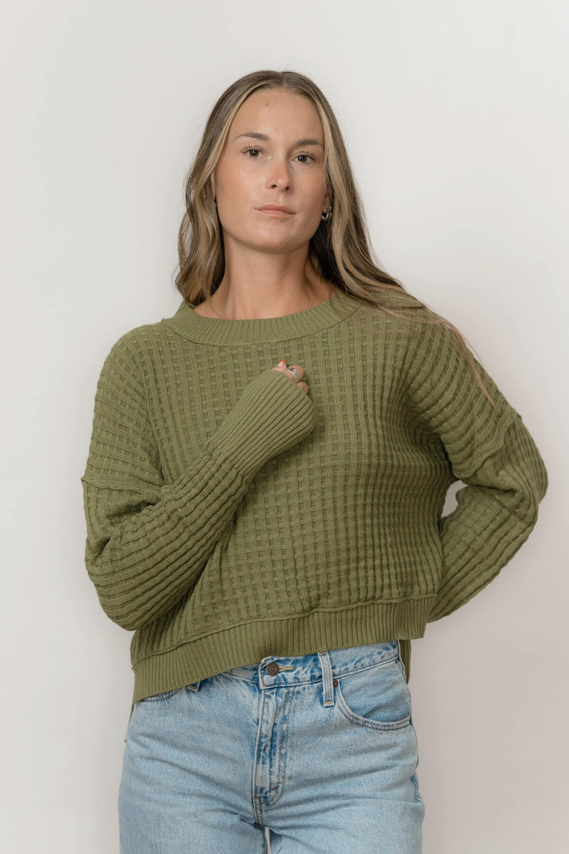 Front view of Echo Verde Sailing Sweater in Thyme green, relaxed high-low hem and long cuffs.