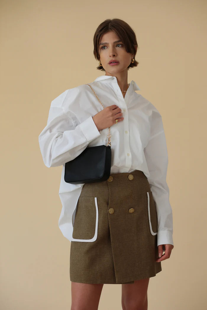 ELA Charlotte crossbody bag black worn on shoulder with gold chain strap Lemonberry Aurora