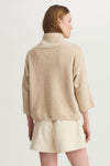 Back view of model wearing Melissa Nepton Ella Sweater in taupe with visible texture and relaxed sleeve.